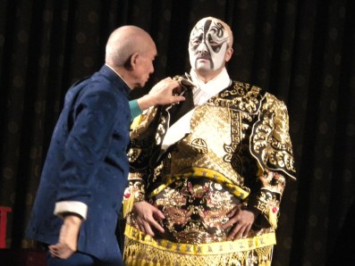 A performer being dressed for the Beijing Opera