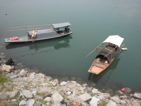 Boats on the river and a man washing his clothes