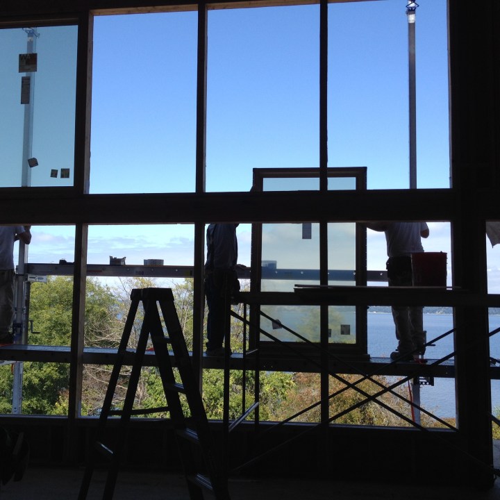 Workmen installing the living-room windows