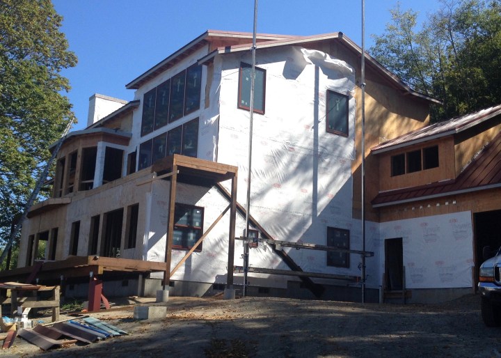 House wrapped with several windows installed
