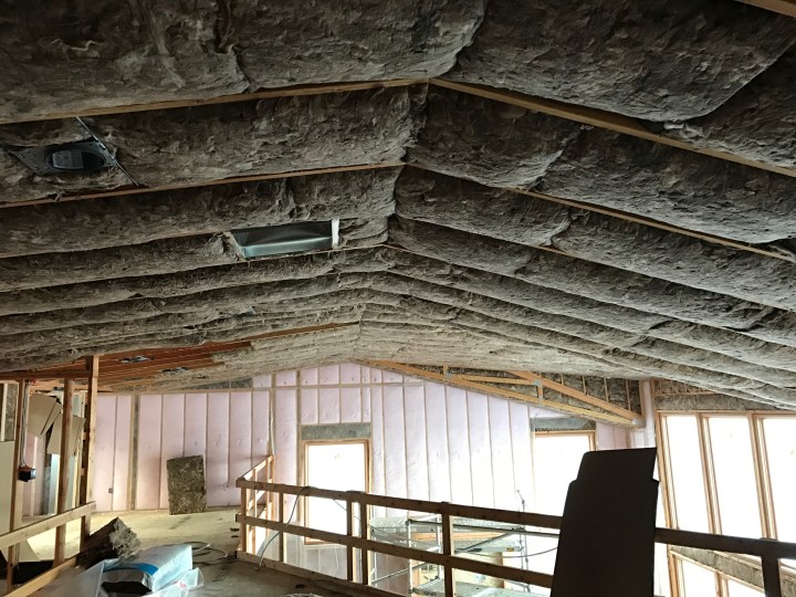 Insulation is complete. Batting in the ceiling and interior walls, blow-in insulation (the pink stuff) in the exterior walls.