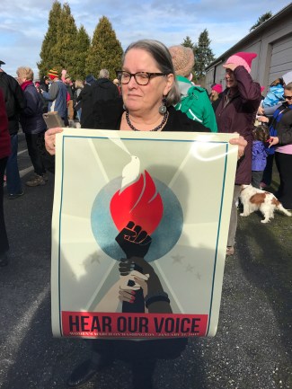 Susanne with a poster given to use by a young man.