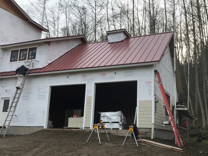 Siding now going on the end and the front of the garage.