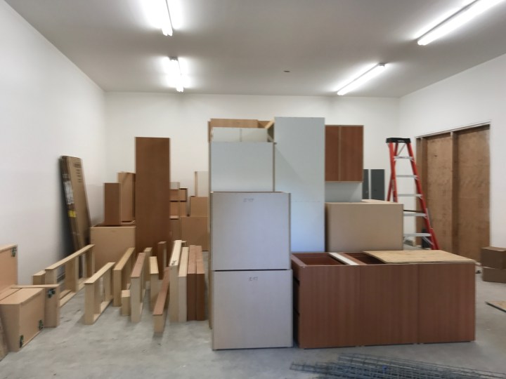 Lights in the garage, with cabinets awaiting installation