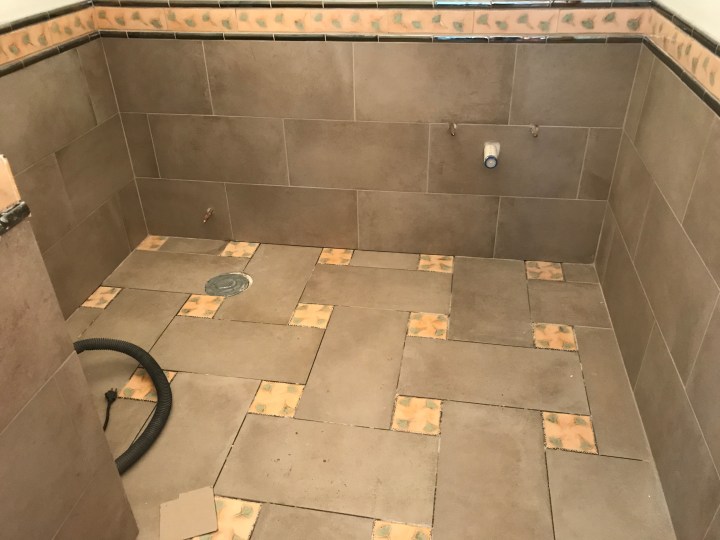 Powder-room tile is all in.
