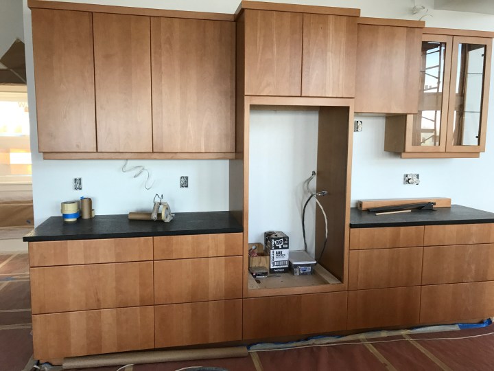 Kitchen cabinets with counter in place. Counters are leathered granite.
