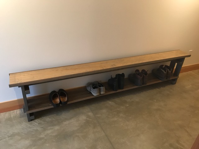 The bench in the first-floor hall, complete with boots.
